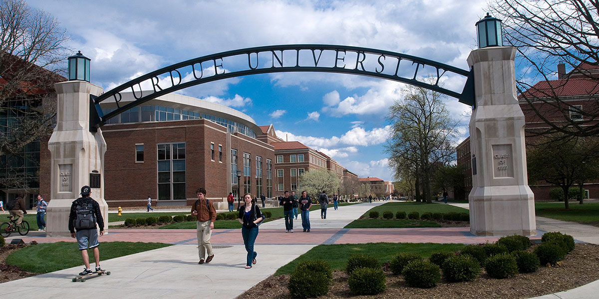 Students walking under the Purdue Arch.